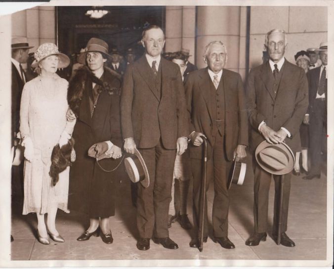 President Coolidge stands beside two of his greatest partners in policy: Secretary Frank B. Kellogg in foreign affairs and Secretary Andrew W. Mellon in domestic business, particularly tax policy. 