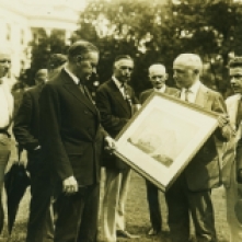 President Coolidge, on the White House grounds, reviews plans for the National Press Building later that same year, September 15, 1925.