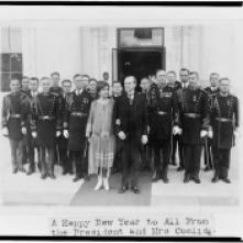 President and Mrs. Coolidge with military aides, just after they assisted in a New Year reception, posed outside the White House 1-1-1927