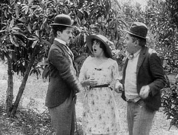 Chaplin and Sennett seen together in The Fatal Mallet, 1914. Mabel Normand stands between them. 