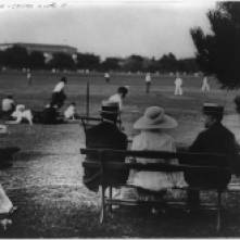 The Coolidges (son John, Grace and Calvin) watch an open field baseball game