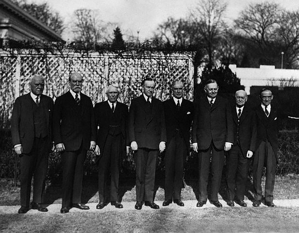 Members of the Pan American Conference to assemble in Havana, standing here on the grounds of the White House. L to R, they are: Judge Morgan J. O'Brien, New York; Charles Evans Hughes; Secretary of State Kellogg; President Coolidge; Henry P. Fletcher, American Ambassador to Italy; former Senator Oscar W. Underwood; Dr. James Scott Brown, Washington; and Dr. L. S. Rowe of the Pan American Union. 