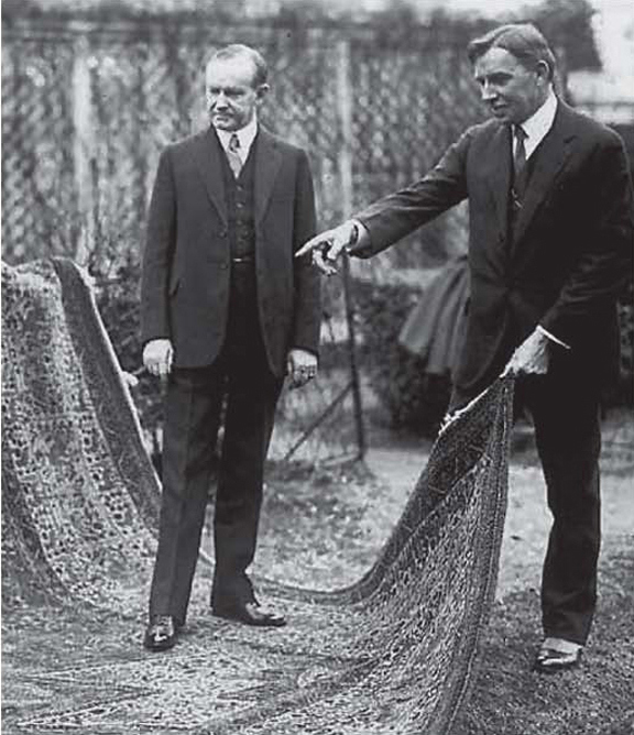 President Coolidge and Dr. Finley admiring the beautiful rug hand-made by the orphans rescued by the Kunzlers, White House lawn, 1925. 