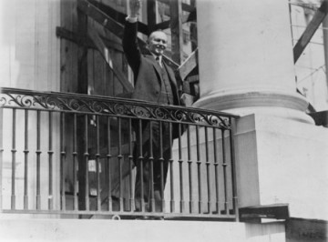 Photograph of President Coolidge waving a greeting to the throngs of children gathered in the White House grounds to roll Easter eggs, April 18th 1927.