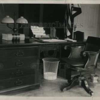 One of Coolidge's regular habits when kept at his desk for long stretches of time was removing his shoes and placing his feet in the most comfortable place he could think of...inside the waste paper basket. It appears the photographer caught the placement of the bin even in the President's absence. Photo credit: HistoricImages.