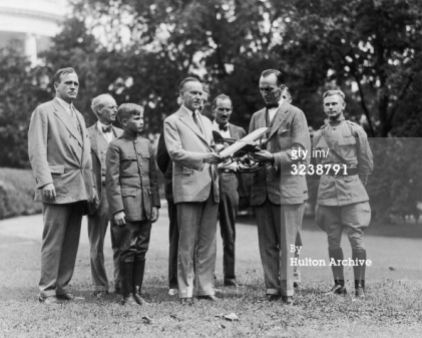 14th September 1925 Lt aviator Eddie Rickenbacker shows U.S. president Calvin Coolidge a model airplane on the grounds of the White House. Invited CC to New York Air Races.