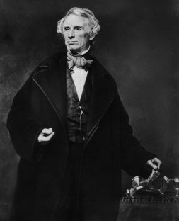 Samuel B. Morse with his telegraph, bequeathing not only "What hath God wrought" to the world but also his universal code and the first international communications line.